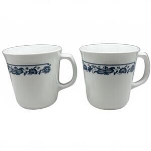 Two white Corning Ware Old Town Blue ceramic mugs with blue floral border.